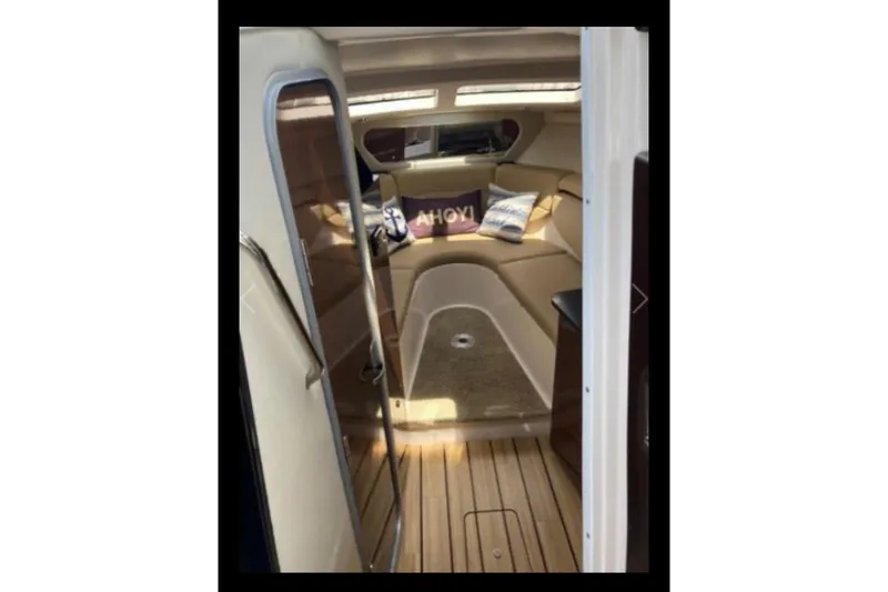 Slide: The Image of 2013 Regal 30 Express cabin interior with wood flooring and cozy seating area. - 20