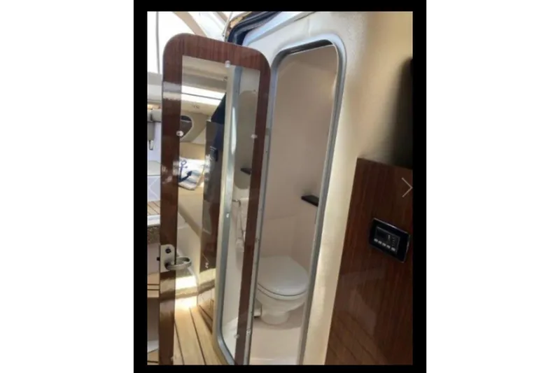 Slide: The Image of 2013 Regal 30 Express yacht interior bathroom with modern design and wooden accents. - 24