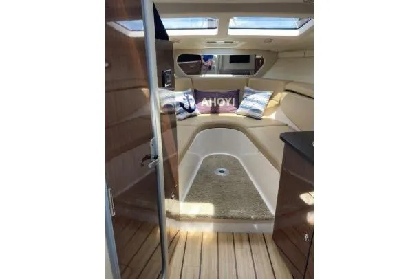 Slide: The Image of 2013 Regal 30 Express cabin interior with wood flooring and cozy seating area. - 25