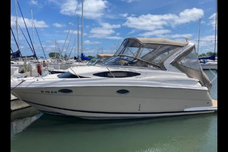 Slide: The Image of 2013 Regal 30 Express boat docked at marina under blue sky. - 3