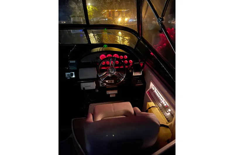 Slide: The Image of Cockpit of 2013 Regal 30 Express boat with illuminated dashboard at night. - 33