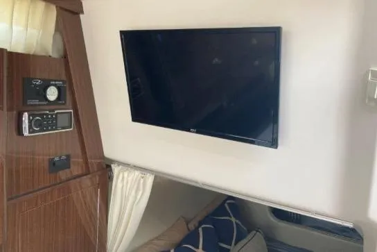 Slide: The Image of Interior of 2013 Regal 30 Express boat with TV and control panel. - 34