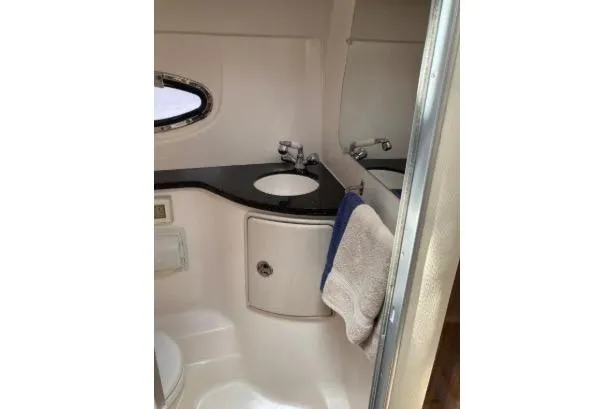 Slide: The Image of 2013 Regal 30 Express boat bathroom with sink, mirror, and towel. - 36