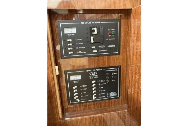 Slide: The Image of Electrical panel of 2013 Regal 30 Express boat, featuring AC and DC power controls. - 37