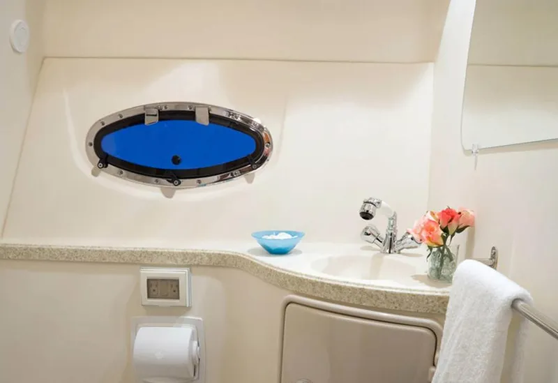 Slide: The Image of Manufacturer Provided Image: 2013 Regal 30 Express boat bathroom with sink, porthole, and flowers. - 38