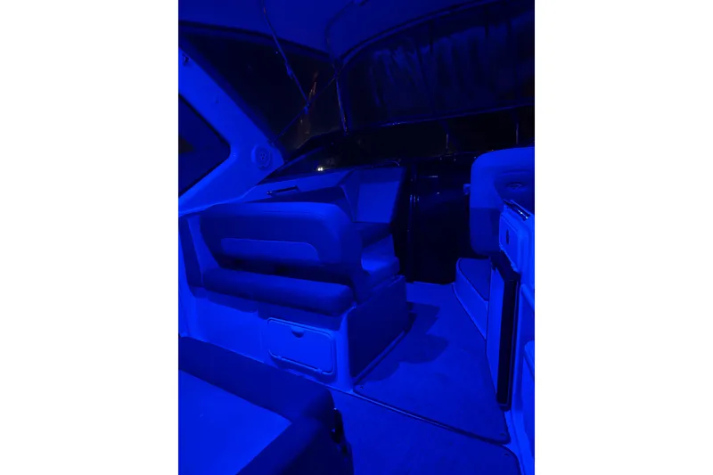 Slide: The Image of Interior of 2013 Regal 30 Express boat illuminated in blue lighting. - 39