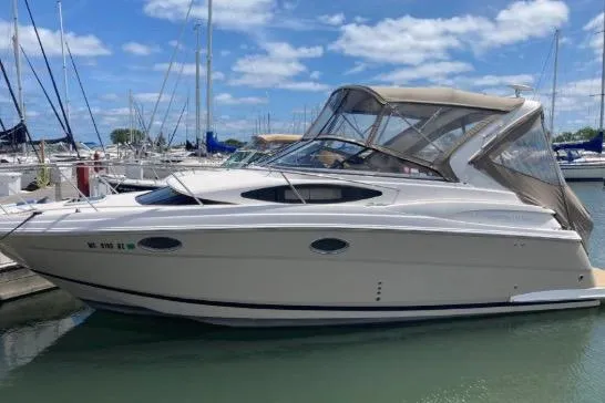 Slide: The Image of 2013 Regal 30 Express boat docked in marina under clear blue sky. - 4