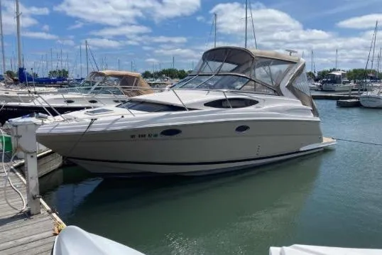 Slide: The Image of 2013 Regal 30 Express boat docked in a marina under a partly cloudy sky. - 5