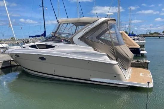 Slide: The Image of 2013 Regal 30 Express boat docked in a marina under a clear blue sky. - 6