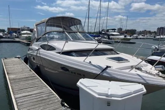 Slide: The Image of 2013 Regal 30 Express boat docked at marina under blue sky. - 9
