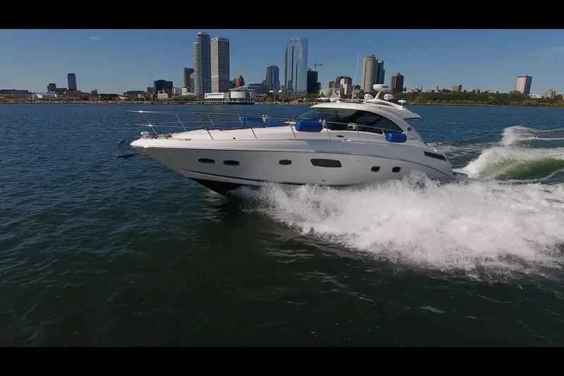 The Image of 2011 Sea Ray 470 Sundancer cruising near city skyline on a sunny day. - 0