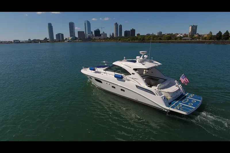 Slide: The Image of 2011 Sea Ray 470 Sundancer yacht cruising near city skyline on a sunny day. - 11