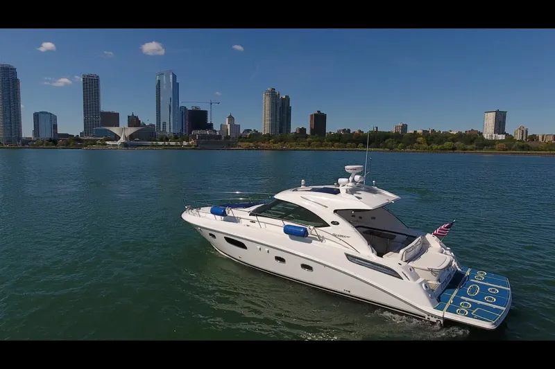 Slide: The Image of 2011 Sea Ray 470 Sundancer yacht cruising near city skyline on a sunny day. - 18