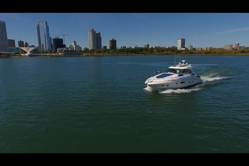 Slide: The Image of 2011 Sea Ray 470 Sundancer cruising near city skyline on a sunny day. - 20