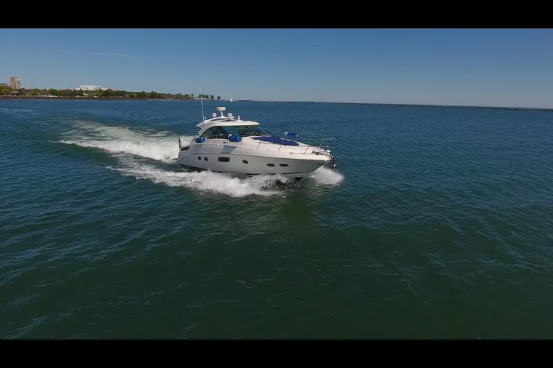 Slide: The Image of 2011 Sea Ray 470 Sundancer cruising on open water under clear skies. - 22