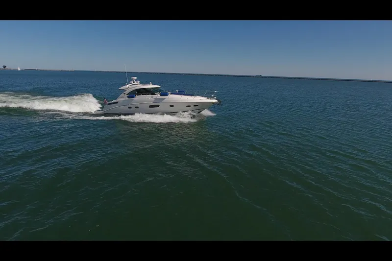 Slide: The Image of 2011 Sea Ray 470 Sundancer cruising on open water under clear skies. - 23