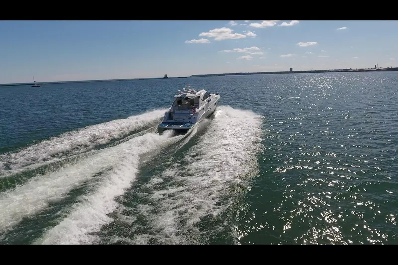 Slide: The Image of 2011 Sea Ray 470 Sundancer cruising on open water under a clear blue sky. - 25