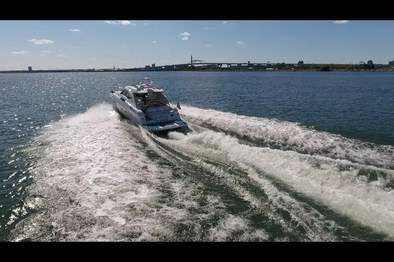 Slide: The Image of 2011 Sea Ray 470 Sundancer cruising on open water, leaving a wake behind. - 26