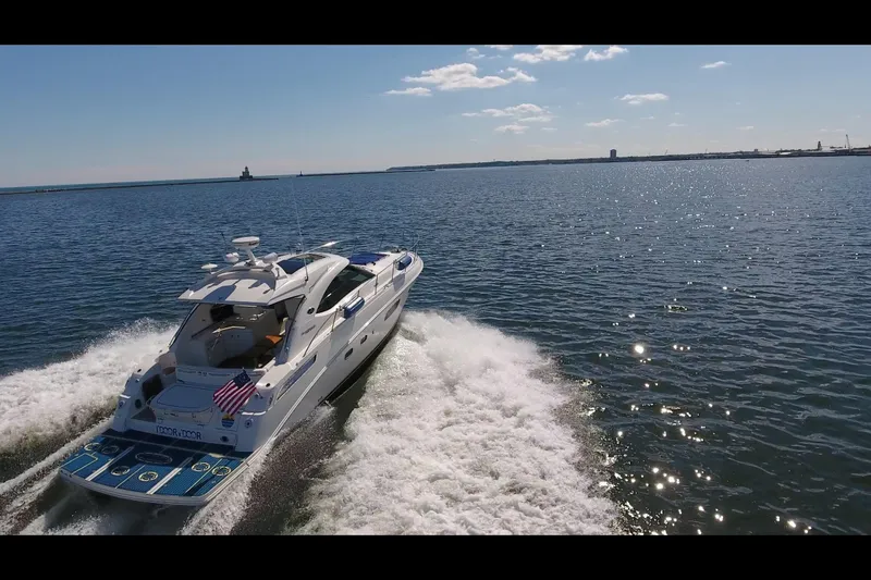 Slide: The Image of 2011 Sea Ray 470 Sundancer cruising on open water under a clear sky. - 28