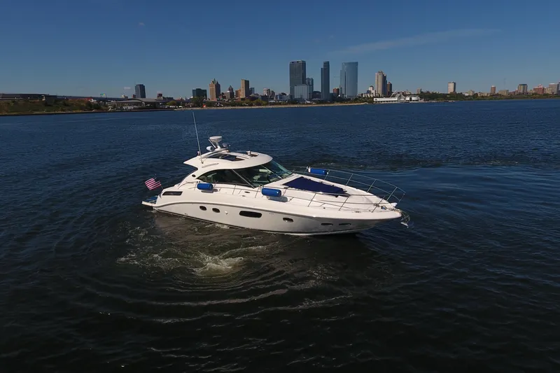 Slide: The Image of 2011 Sea Ray 470 Sundancer yacht cruising near city skyline on a sunny day. - 3