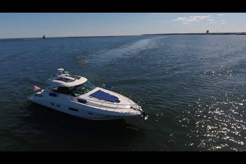 Slide: The Image of 2011 Sea Ray 470 Sundancer yacht cruising on open water under clear skies. - 35