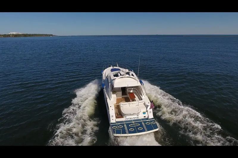 Slide: The Image of 2011 Sea Ray 470 Sundancer cruising on open water, rear view. - 36