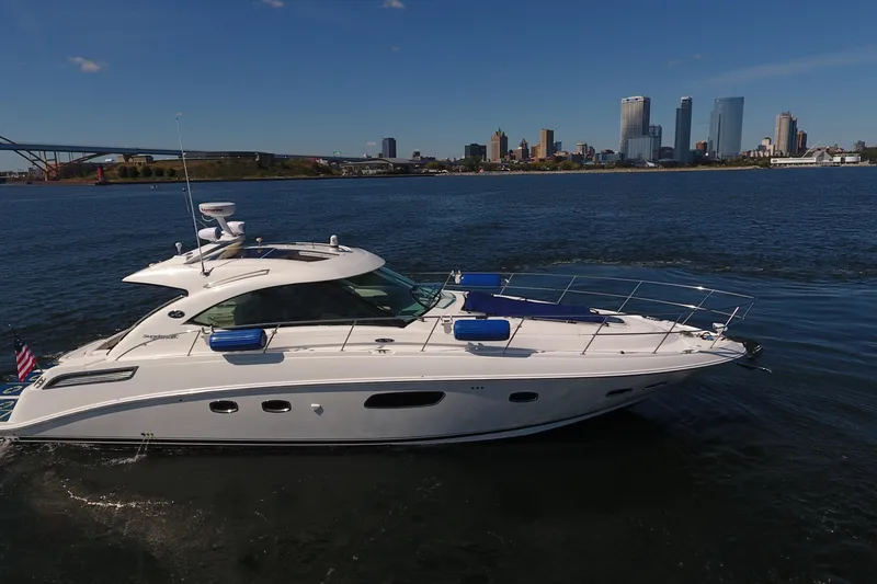 Slide: The Image of 2011 Sea Ray 470 Sundancer yacht cruising near city skyline on a sunny day. - 5