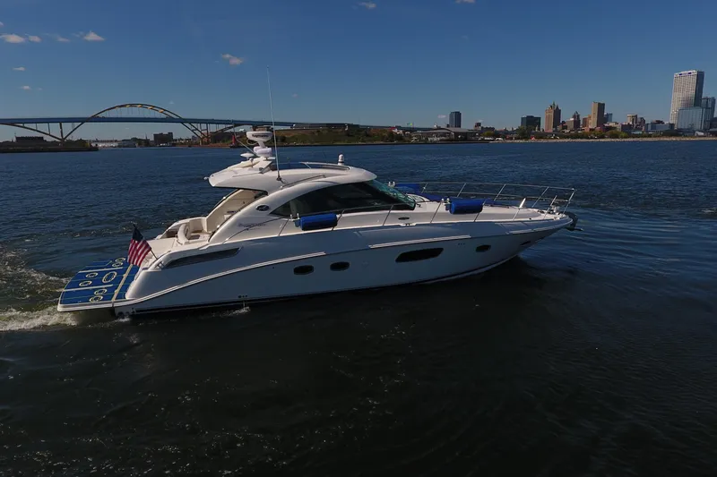 Slide: The Image of 2011 Sea Ray 470 Sundancer yacht cruising near city skyline and bridge. - 6