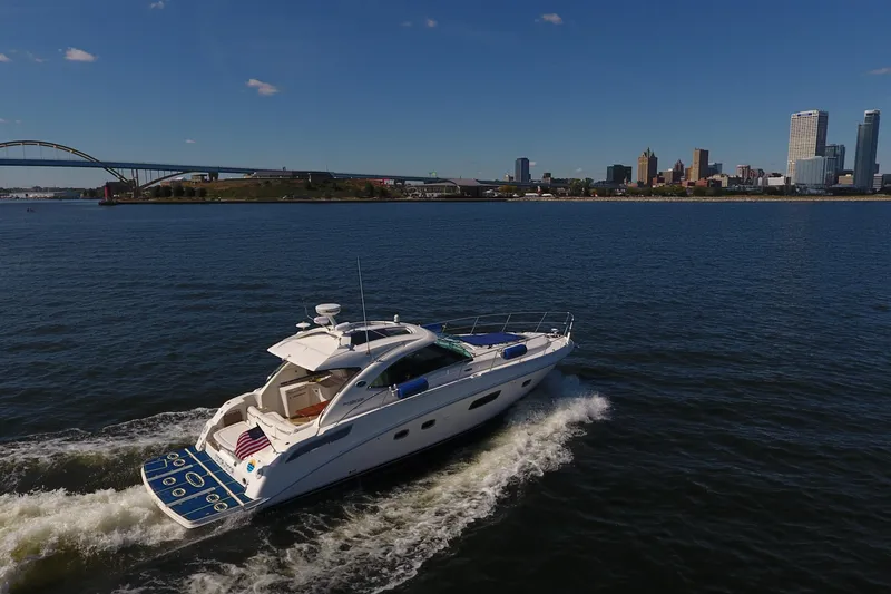 Slide: The Image of 2011 Sea Ray 470 Sundancer cruising near city skyline and bridge on a sunny day. - 8