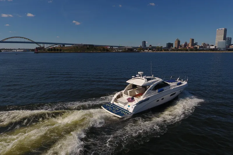 Slide: The Image of 2011 Sea Ray 470 Sundancer cruising on a sunny day near city skyline and bridge. - 9