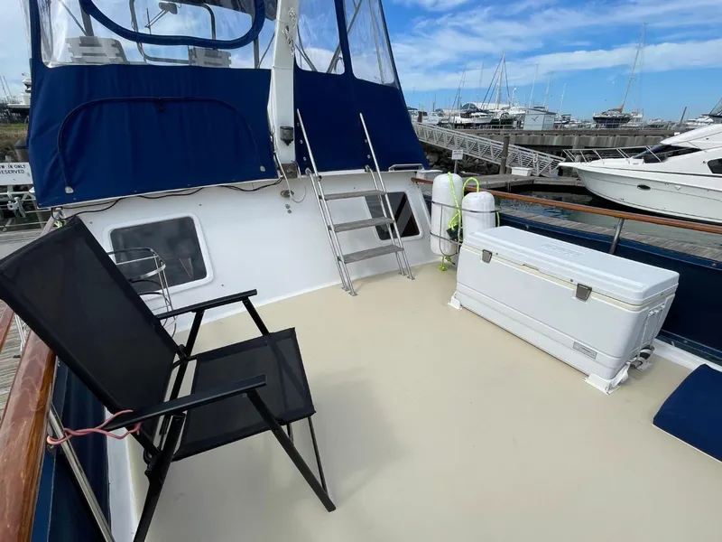 Slide: The Image of 1983 Ocean Alexander TRI Cabin yacht deck with chairs and storage box. - 13