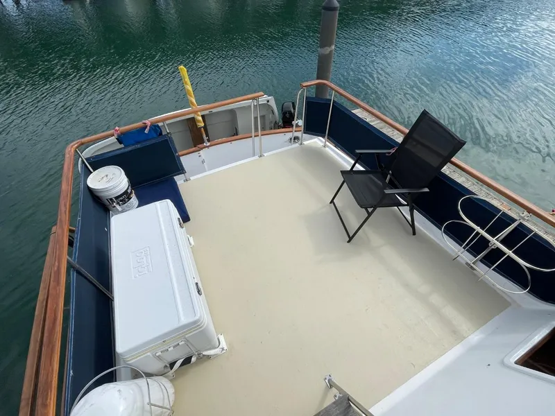 Slide: The Image of 1983 Ocean Alexander TRI Cabin deck with seating and cooler. - 15