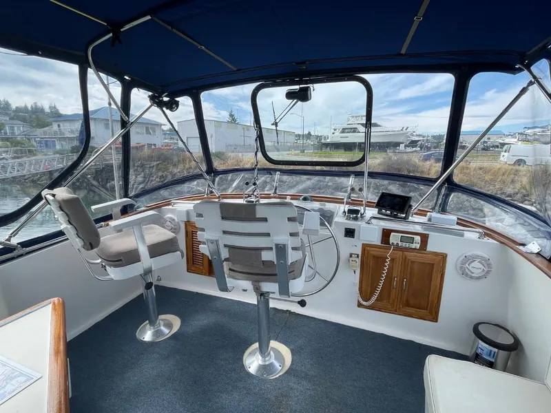Slide: The Image of 1983 Ocean Alexander TRI Cabin helm with panoramic windows and dual captain chairs. - 18