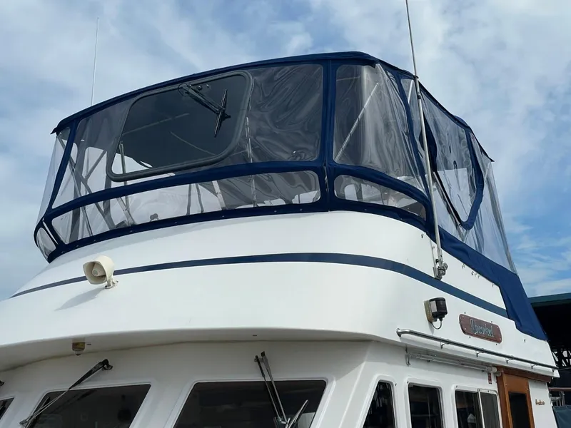 Slide: The Image of 1983 Ocean Alexander TRI Cabin yacht with blue canvas enclosure. - 2