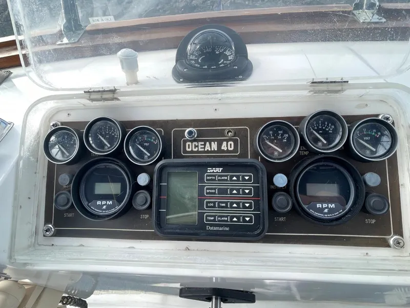 Slide: The Image of 1983 Ocean Alexander TRI Cabin dashboard with gauges and controls. - 24