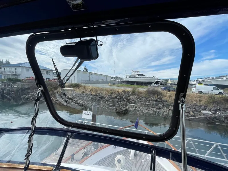 Slide: The Image of View from the 1983 Ocean Alexander TRI Cabin yacht's cabin window at a marina. - 25