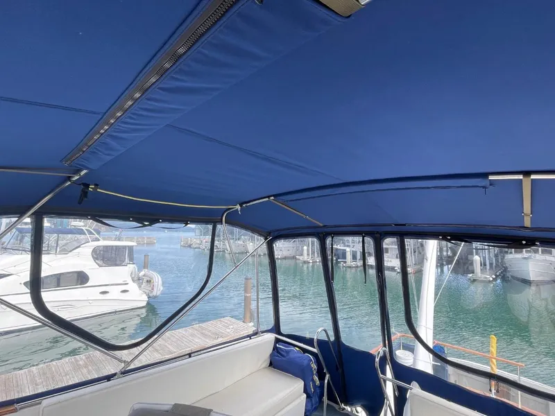 Slide: The Image of Interior view of 1983 Ocean Alexander TRI Cabin yacht with blue canopy. - 27