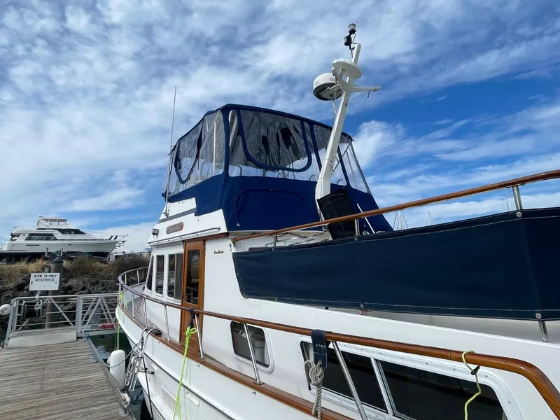 Slide: The Image of 1983 Ocean Alexander TRI Cabin yacht docked at marina under blue sky. - 3
