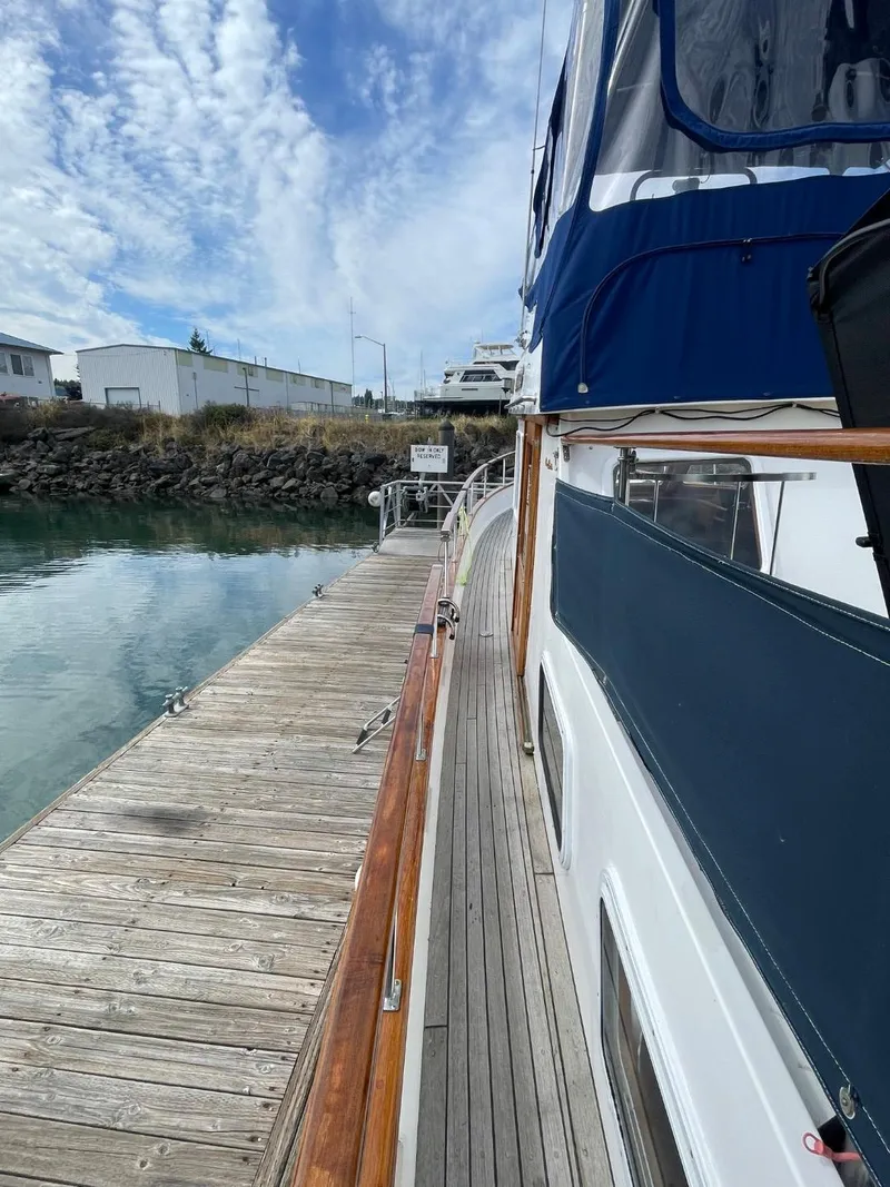 Slide: The Image of 1983 Ocean Alexander TRI Cabin yacht docked at a marina. - 4