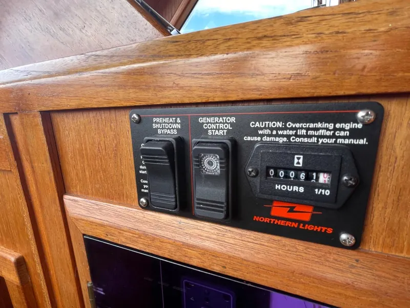 Slide: The Image of Control panel of a 1983 Ocean Alexander 40 Double Cabin boat with generator settings. - 40