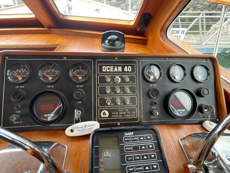 Slide: The Image of Control panel of 1983 Ocean Alexander 40 Double Cabin yacht with gauges and navigation equipment. - 42