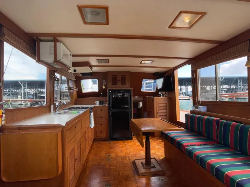 Slide: The Image of Interior of 1983 Ocean Alexander 40 Double Cabin with wood finish and striped seating. - 48