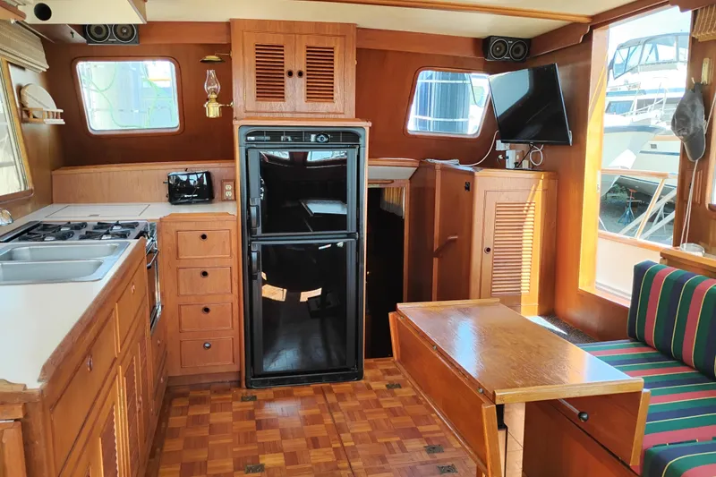 Slide: The Image of Interior of 1983 Ocean Alexander 40 Double Cabin with kitchen and seating area. - 49