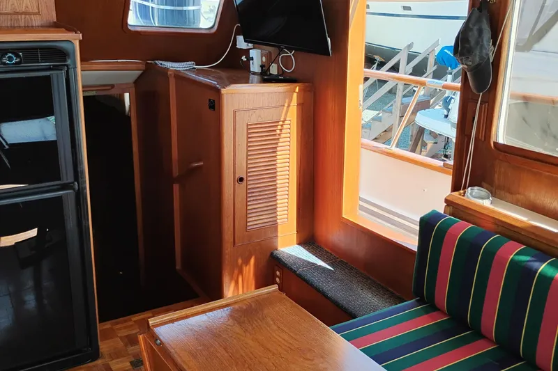 Slide: The Image of Interior of 1983 Ocean Alexander 40 Double Cabin with wood finish and striped seating. - 50