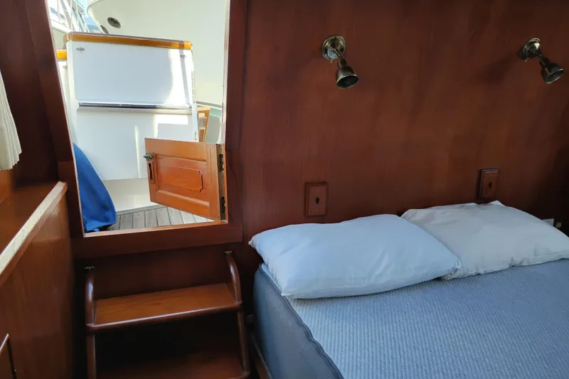 Slide: The Image of Interior of 1983 Ocean Alexander 40 Double Cabin with bed and wooden decor. - 55