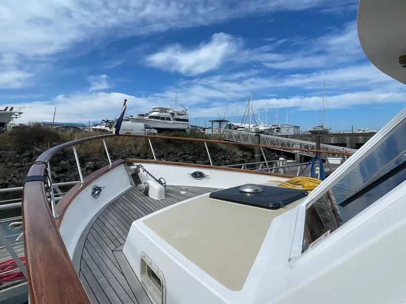 Slide: The Image of 1983 Ocean Alexander TRI Cabin yacht docked at marina under blue sky. - 6