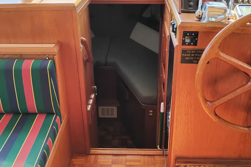 Slide: The Image of Interior of 1983 Ocean Alexander 40 Double Cabin with wooden helm and striped seating. - 64