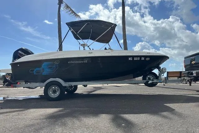 The Image of 2018 Bayliner Element E18 boat on trailer under a sunny sky. - 0
