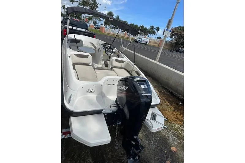 Slide: The Image of 2018 Bayliner Element E18 boat with Mercury 60 engine, parked outdoors. - 3