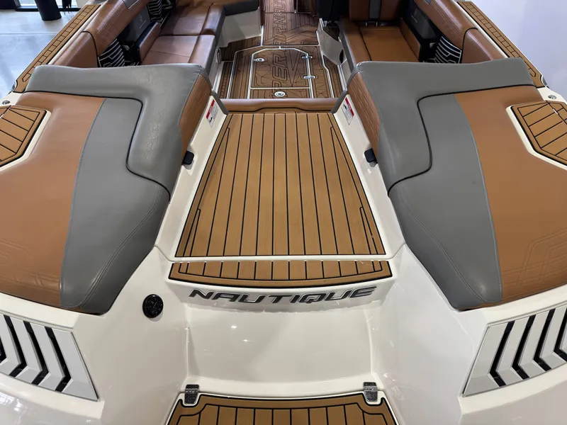 Slide: The Image of 2019 Nautique Super Air Nautique G25 interior with brown and gray seating. - 10